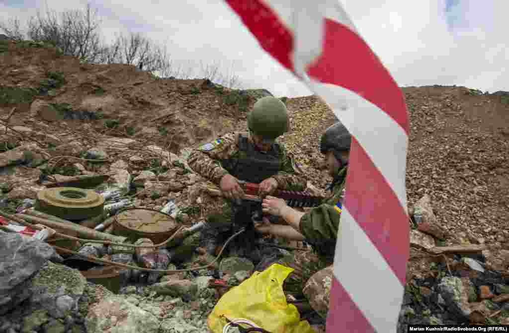 Ukrainian sappers deal with mines and unexploded shells that have landed near their positions.