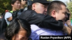 Kazakh law enforcement officers detain participants at an opposition rally in Almaty on September 21.