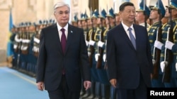 Kazakh President Qasym-Zhomart Toqaev (left) welcomes Chinese leader Xi Jinping to Astana on July 2 for a state visit and two-day SCO summit. 