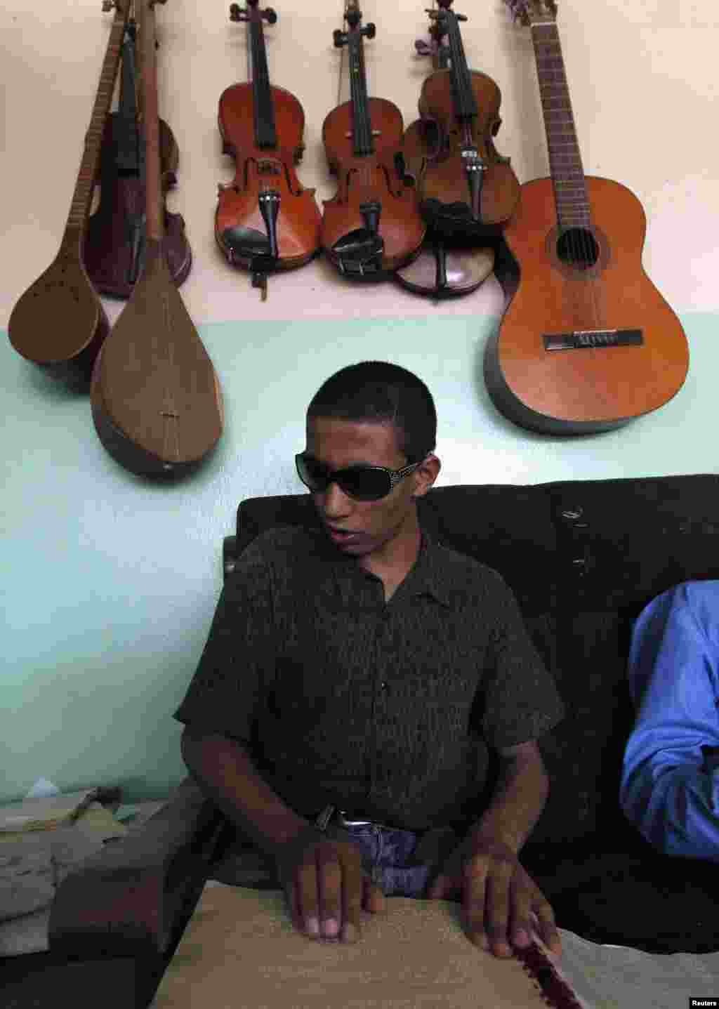 A blind student reads Braille during a music lesson at the Kabul Blind School.