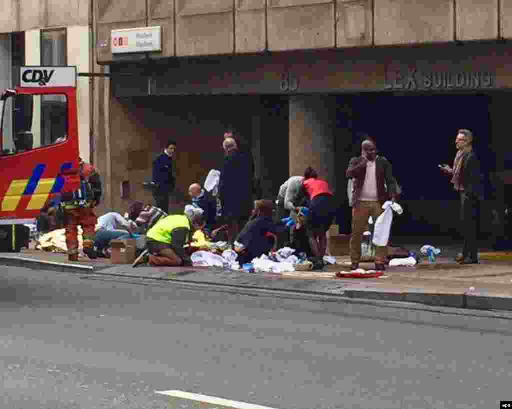 Emergency personnel tend injured people after the explosion at Maalbeek station.