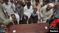 Relatives and colleagues carry the casket of journalist Syed Saleem Shahzad, whose body was found abandoned in a canal on May 31. 