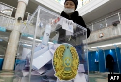 A woman votes during Kazakhstan's parliamentary election in Nur-Sultan on January 10, 2021.