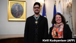 Kirill Serebrennikov (left) poses with French Ambassador Sylvie Bermann at the French Embassy in Moscow on October 14.