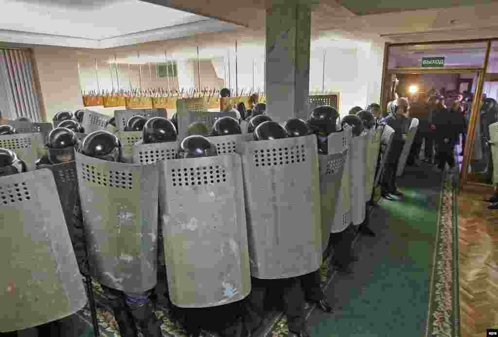 Riot police stand guard inside the parliament building in Simferopol.