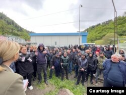 Workers gather outside of one of Borjomi’s two bottling plants on May 30.