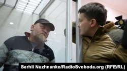 Nadia Savchenko (right) speaks on March 9 in a Kyiv courtroom with Volodymyr Ruban, who was arrested and charged with planning to kill President Petro Poroshenko and other top government officials.