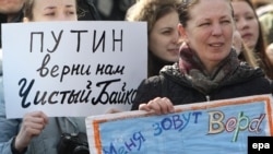 A woman holds a poster reading "Putin, give us a clean Baikal back" at a demonstration in Moscow in March.