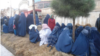 Displaced women from the Darzab and Qush-Teppa districts wait for assistance in Sheberghan.