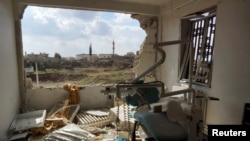 A damaged clinic is shown after air strikes by Syrian government forces in the rebel-held town of Al-Ghariyah al-Gharbiyah in Deraa Province on February 11.