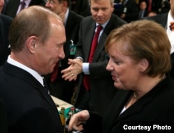 Russian President Vladimir Putin talks to German Chancellor Angela Merkel at the 2007 Munich Security Conference, an event that set the tone for tense relations between Moscow and the West.