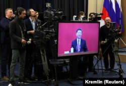 Chinese President Xi Jinping is seen on a screen during a video link at a ceremony launching Gazprom's Power of Siberia gas pipeline from Russia to China in Sochi, Russia, in December 2019.