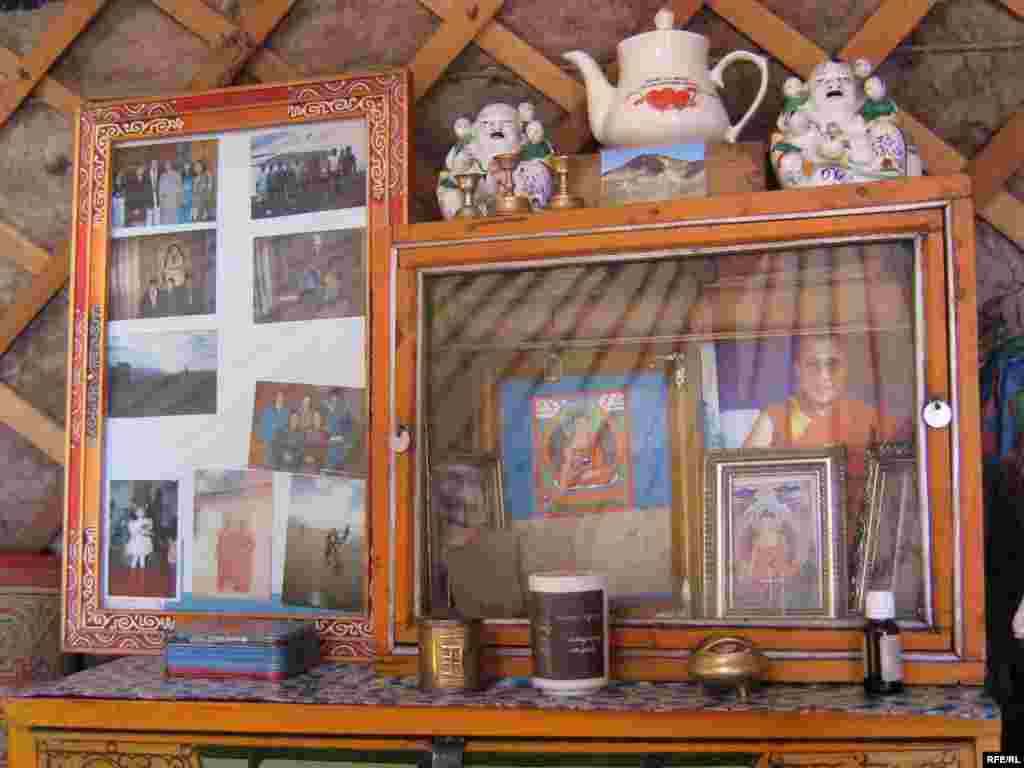 A family shrine in a Mongolian ger. - Mongolian nomads keep possessions to a minimum, but every ger includes a small, brightly colored shrine that mixes family photographs with prayer wheels, incense burners, and Buddhist figurines. Life in gers is conducted according to standard rules and traditions. First-time visitors must enter to the left, and only move within the ger in a clockwise direction. Family elders and respected visitors occupy the right side of the ger.