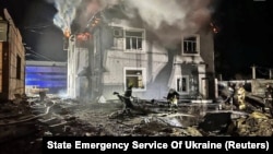 Firefighters work at a site where production facilities were damaged during a Russian drone strike in the Kyiv region on January 30. 