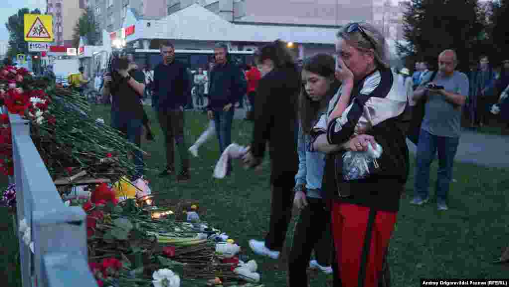 Mourners leave flowers at a makeshift memorial near School No. 175.