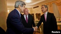 U.S. Secretary of State John Kerry (left) meets with Moldovan President Nicolae Timofti (center) and Prime Minister Iurie Leanca at the official residence in Chisinau on December 4.