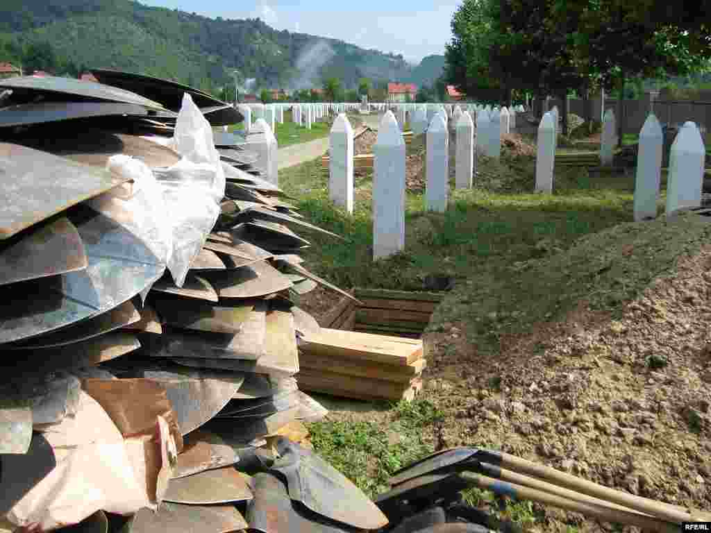 Workers dig graves in preparation for the mass burial at Potocari.