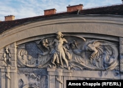 A crumbling facade from a residential building constructed in 1905. The dragon-wrangling hero overlooks Budapest's City Park.