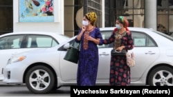 Turkmen women wear protective face masks as a preventive measure against the spread of COVID-19 in Ashgabat. 