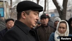 Kazakh rights activist Serikzhan Bilash speaks to reporters outside a courthouse in Almaty last month.