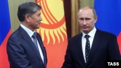 Almazbek Atambaev (left) with Russian Prime Minister Vladimir Putin in 2010