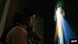 An Indian Christian prays on Christmas Eve in New Delhi