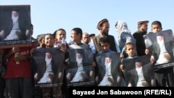 Afghans hold portraits of former Afghan President Burhanuddin Rabbani at an antigovernment demonstration in Kabul last week.