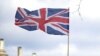 U.K. – A demonstrator holds a British flag during a protest against Russia's invasion of Ukraine, at Parliament Square in London, Britain, March 6, 2022