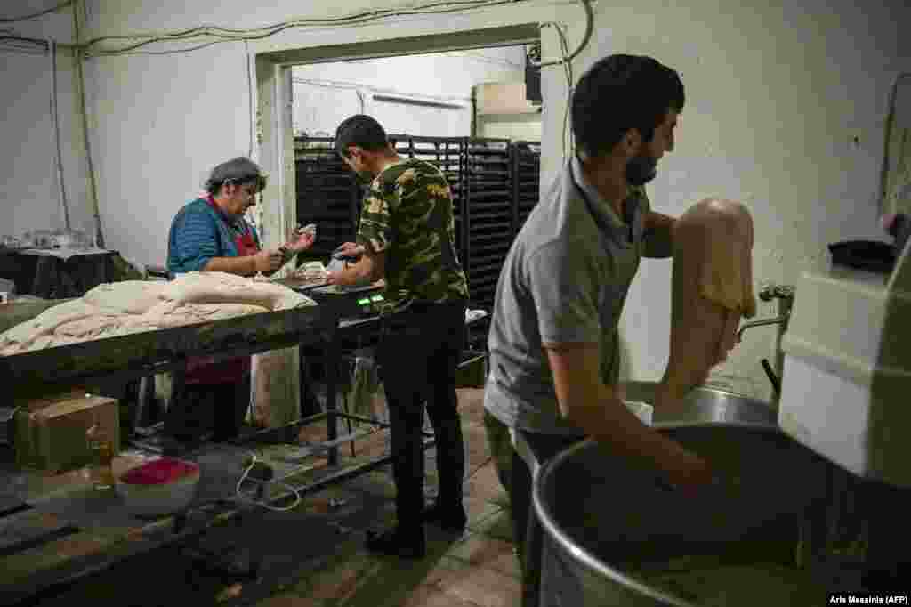 Ghevondian (left) works with colleagues to split the dough into portions before sliding it into an electric oven. The baker&#39;s 20-year-old son is currently fighting on the front lines of the battle for Nagorno-Karabakh. She told AFP:&nbsp; &quot;If my son is there, how could I leave here? I don&#39;t ask for anything else. My house can be destroyed, but I want my son near me.&quot; &nbsp;