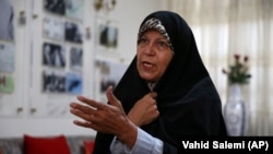 Faezeh Hashemi speaks to an interviewer in Tehran on September 6.