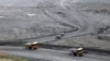 Heavy dump trucks transport waste rock to heaps at the Kumtor gold mine. (file photo)