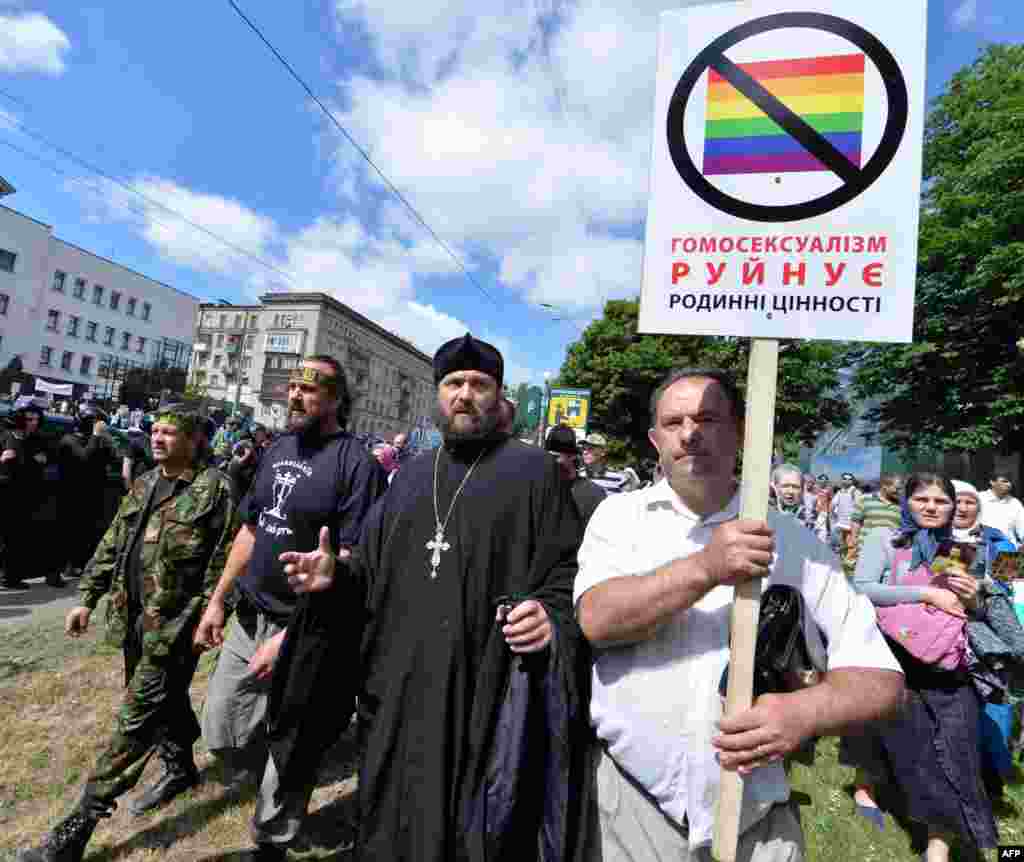 Orthodox believers carry a placard saying &quot;Homosexuality destroys family values&quot; during a counterdemonstration.&nbsp;