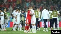 Serbia's Aleksandar Kolarov hugs Switzerland's Josip Drmic after their World Cup match.