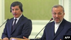 Iranian Foreign Minister Manuchehr Mottaki (right) speaks during a joint press conference with his Turkish counterpart Ahmet Davutoglu following a meeting in Tehran.