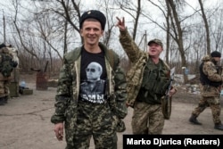 A pro-Russian rebel with a t-shirt depicting Russian President Vladimir Putin at a checkpoint in eastern Ukraine.