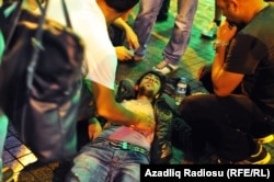 An injured protester is attended to after riot police used tear gas and water cannons to suppress a rally against the demolition of Istanbul's Gezi Park in July 2013.