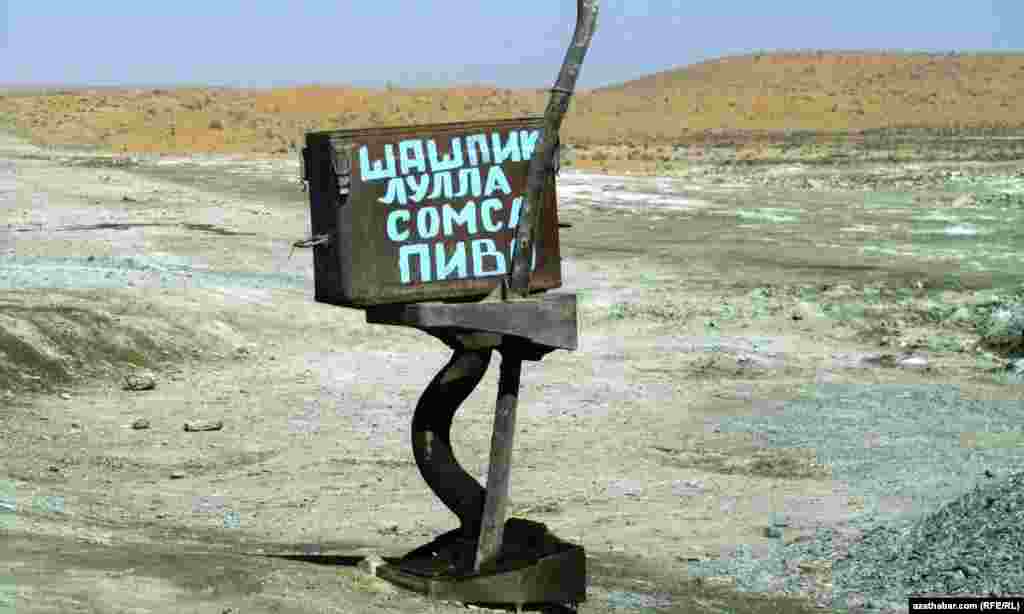 A sign advertises shashlik and beer in a remote region of Turkmenistan.