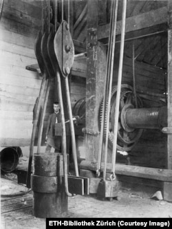 A worker inside an oil derrick