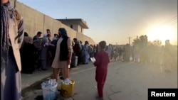 People waiting outside Kabul airport on August 22.