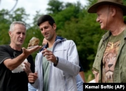 Osmanagic (right) watches Djokovic being shown a crystal in July, during the tennis star’s first of two visits to Visoko.