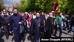 Four priests lead marching opposition protesters in Yerevan on April 22.