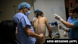 A wounded Armenian soldier is treated by medics outside the city of Stepanakert amid ongoing fighting over Nagorno-Karabakh.