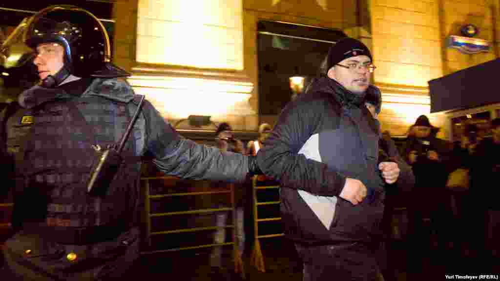 Police detain an activist during a protest rally by the opposition group Another Russia in central Moscow.