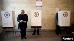 A man holds his ballot at a polling station in Yerevan during parliamentary elections on May 6.