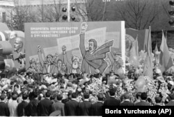 May Day marchers on Red Square carry a placard demanding "an end to imperialistic meddling in Afghanistan" on May 1, 1980.