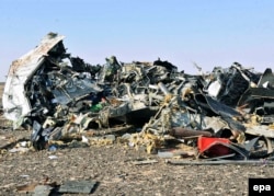 Debris from the crashed Russian jet lies strewn across the sand at the site of the crash in Egypt's Sinai.