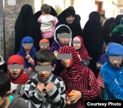 Tajik women and their children await their fate in an Iraqi court in January.