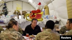 British Prime Minister David Cameron (center) eats breakfast with British forces at Camp Bastion in Helmand Province in December.