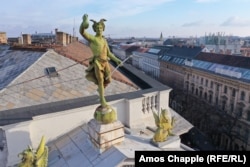 A statue of Hermes looks into the camera from his perch atop the Fonciere Palace, built in 1882 to house an insurance company.