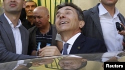 Bidzina Ivanishvili gets into a car as he leaves a polling station during the parliamentary election in Tbilisi on October 1, 2012.